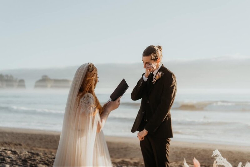 Emily reading her vows to Austin at their elopement on the Washington coast.